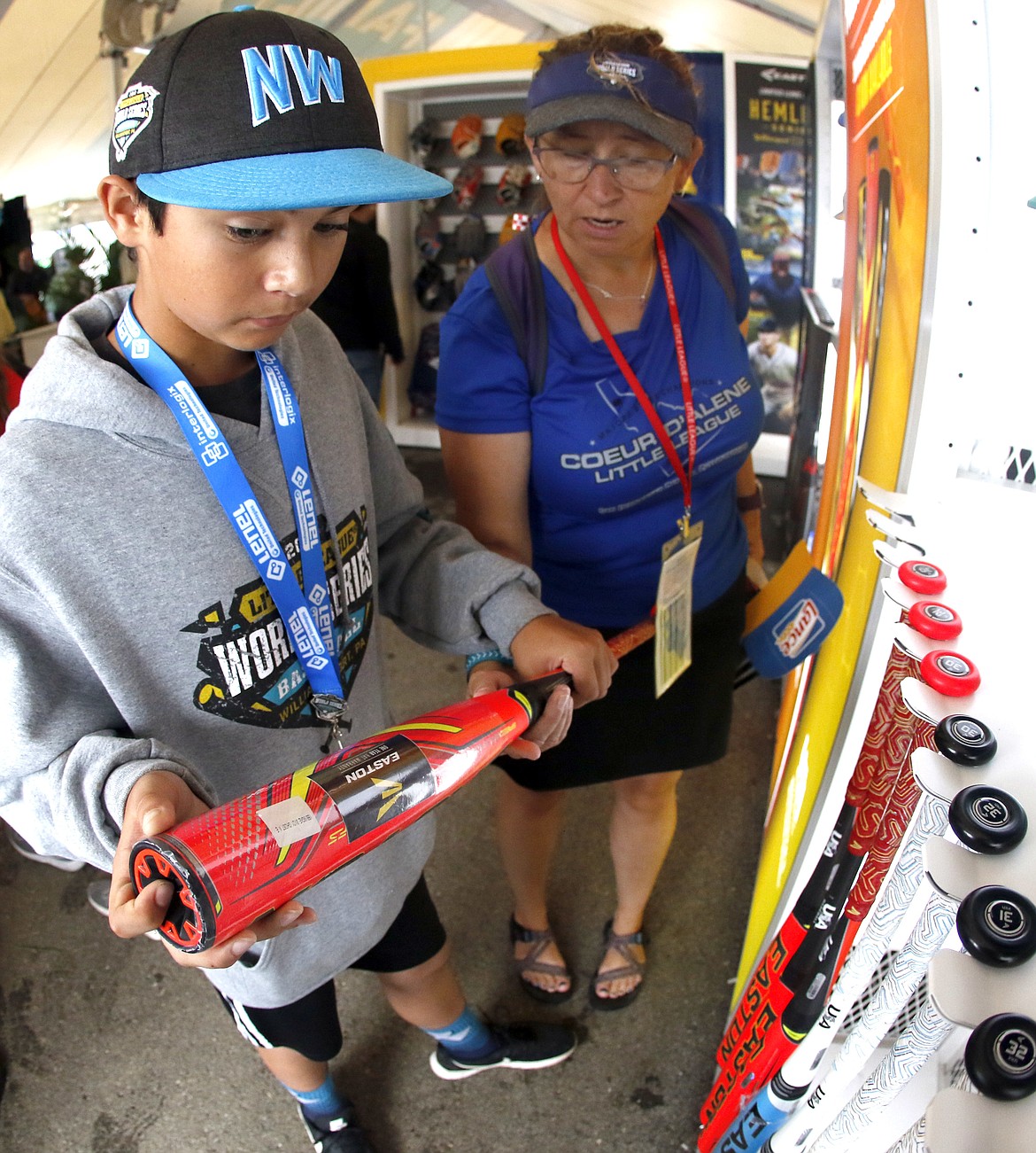 TOM E. PUSKAR/Associated Press
Kyle Seman of the Coeur d’Alene Little League World Series team, and his mother, Heather Seman, check out the 2019 USA Baseball Bats Exclusive LLWS product release at the Easton display at the Little League World Series in South Williamsport, Pa., on Aug. 21, 2018. The new USA baseball bat designed in 2018 to keep the ball in play and pitchers safer from line drives had another effect at the Little League World Series: fewer home runs.