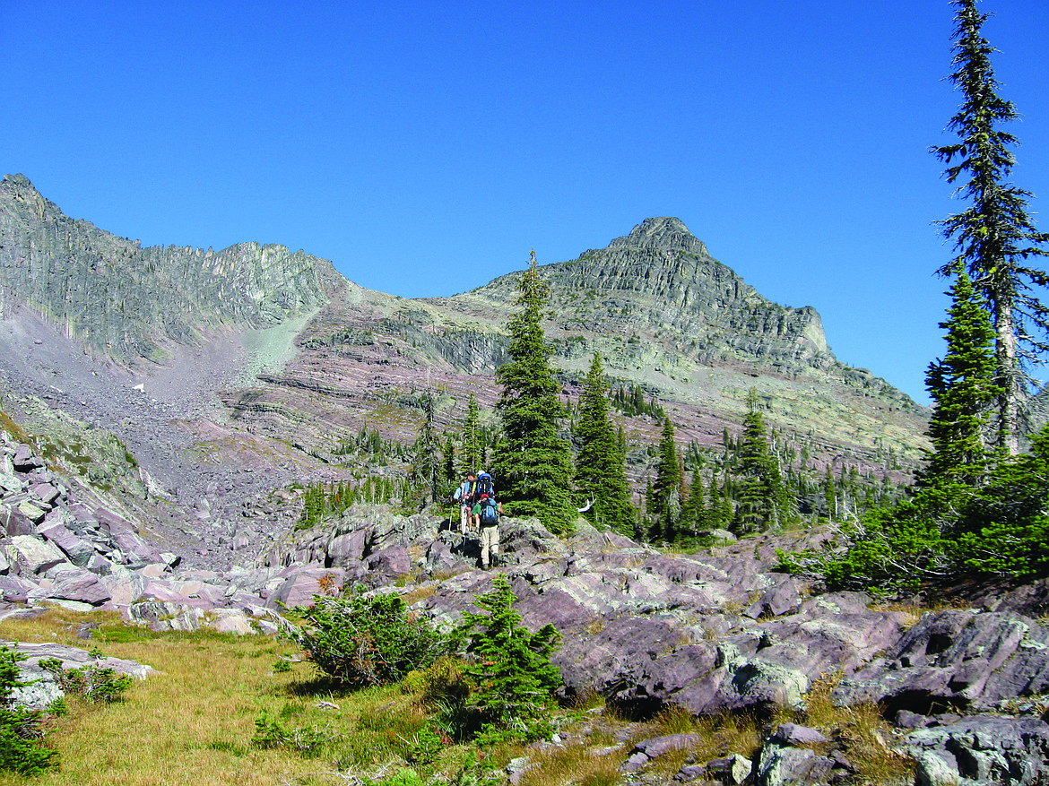 Hikers below McPartland Peak in Glacier National Park in this 2010 file photo. (Rick Hanners/Whitefish Pilot FILE)