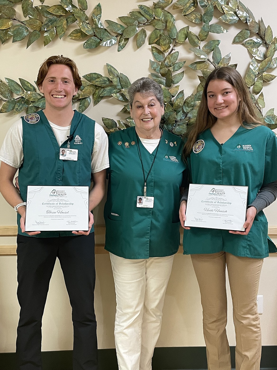 Torin Haesle, left, and Heidi Hansch, right, pose with Margo Johnson, BGH Volunteer Council chair, after being presented scholarship awards.