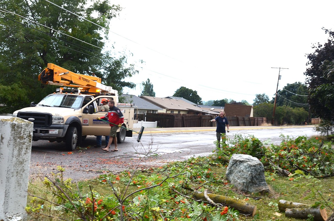 Mission Valley Power crews were busy last Friday when a major storm blew down trees and caused power outages from one end of Lake County to the other. In this instance, they worked with Polson Fire to remove a mountain-ash tree that knocked down a powerline and briefly closed 17th Avenue. (Kristi Niemeyer/Leader)