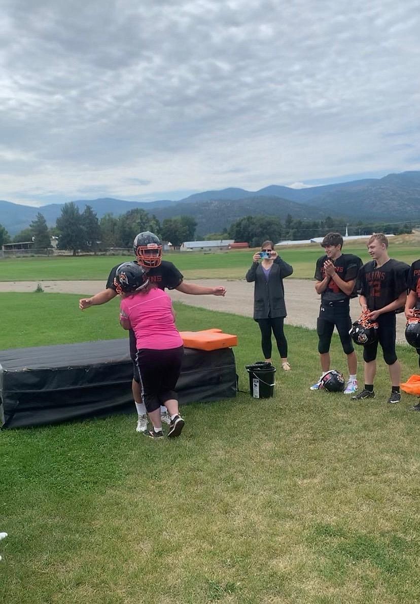 Shawna Tatum, wife of Plains football coach Mike Tatum tackles her son Greg during an after-scrimmage activity Saturday morning at Plains High. (Courtesy photo)