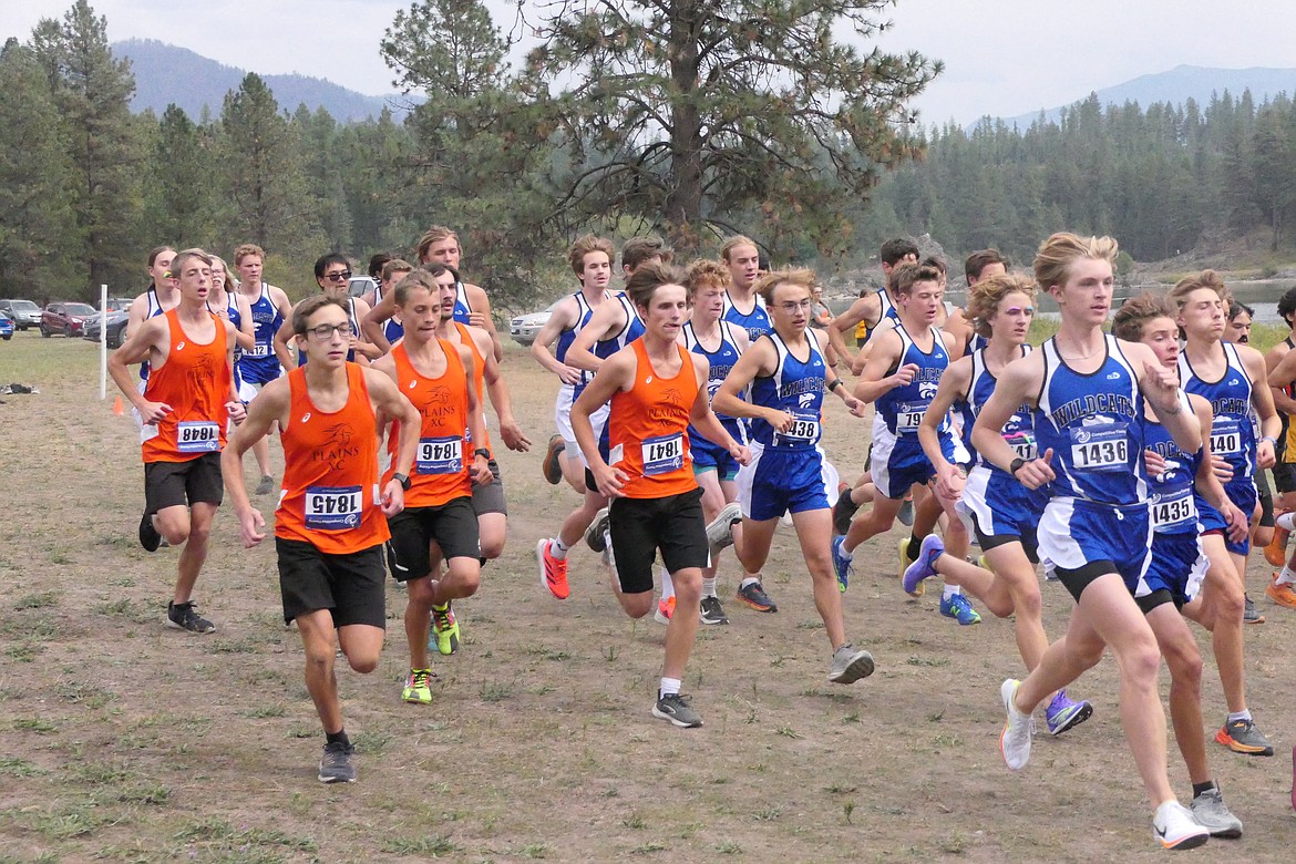 Last season's Plains boys' cross-country team (orange shirts) bursts over the starting line at the T Falls Invitational last year.  The boys return a young, talented team for this season. (File photo)