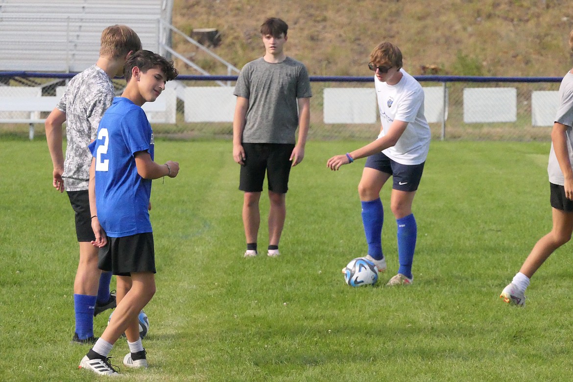 Players for the new co-op girls' soccer team loosen up with a passing drill during practice this past week in Thompson Falls. The boys and girls teams open their first varsity season this Saturday in Thompson Falls. (Chuck Bandel/VP-MI)