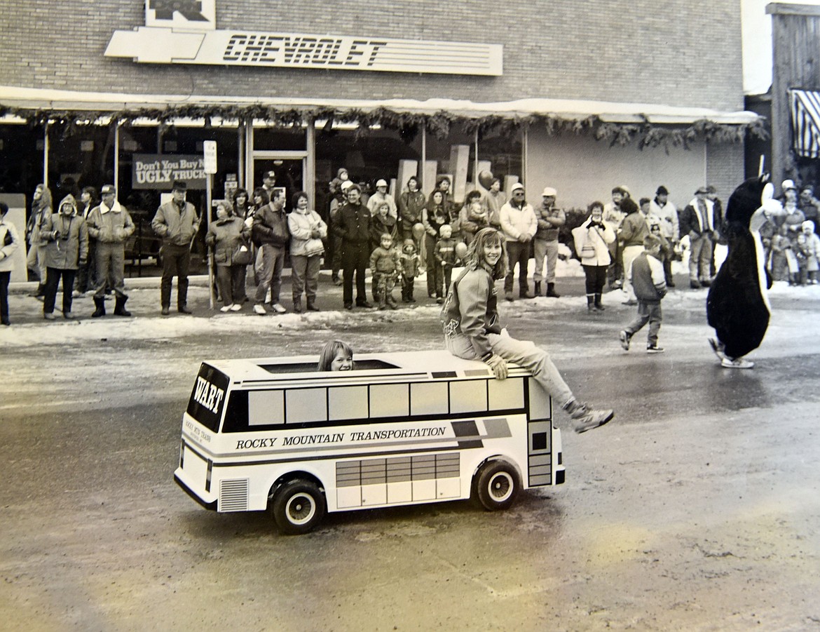 A child drives a Rocky Mt. Transportation mini bus during the Whitefish Carnival parade. Print photo provided by Duff at the Railway Depot.