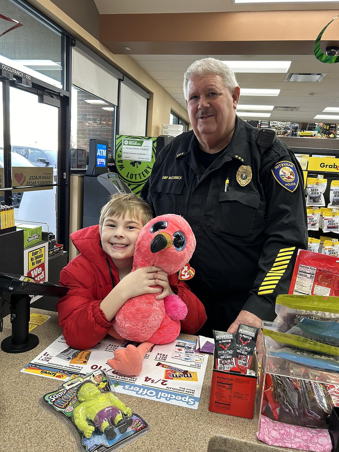 Ritzville Police Chief Dave McCormick, with a participant in Shop with a Cop 2023. After more than three decades in law enforcement, McCormick has announced his retirement effective Sept. 30.