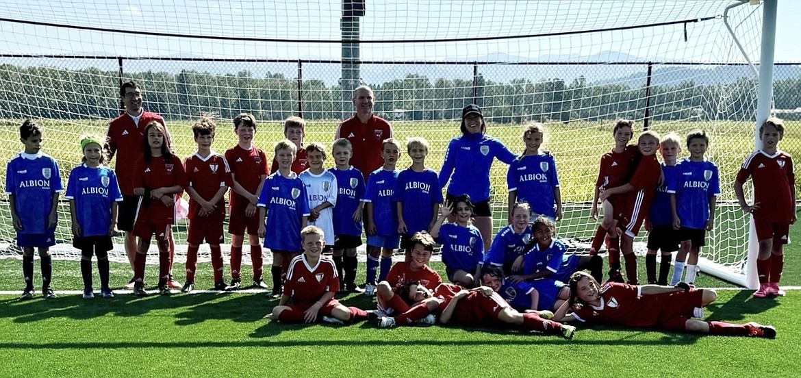 The Sandpoint Albion Idaho SC 2015/16 co-ed team (blue) and Kootenay Storm SC co-ed 2014/15 team (red), and their coaches, are all smiles after an international friendly at the new Field of Dreams sports complex in Ponderay.