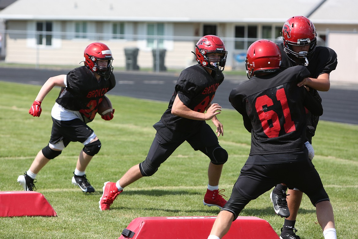 Bronco players compete during a drill at Saturday’s practice in Ritzville. Running backs attempt to weave their way through blockers and defenders, all while staying in bounds.