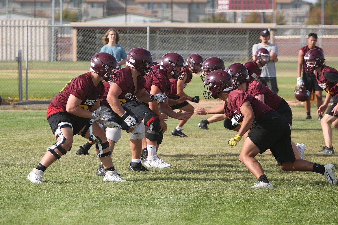 The Moses Lake offensive line gets set for a play against the scout team defense during an August 21 practice. Moses Lake returns each of its starters on the offensive line from a season ago.