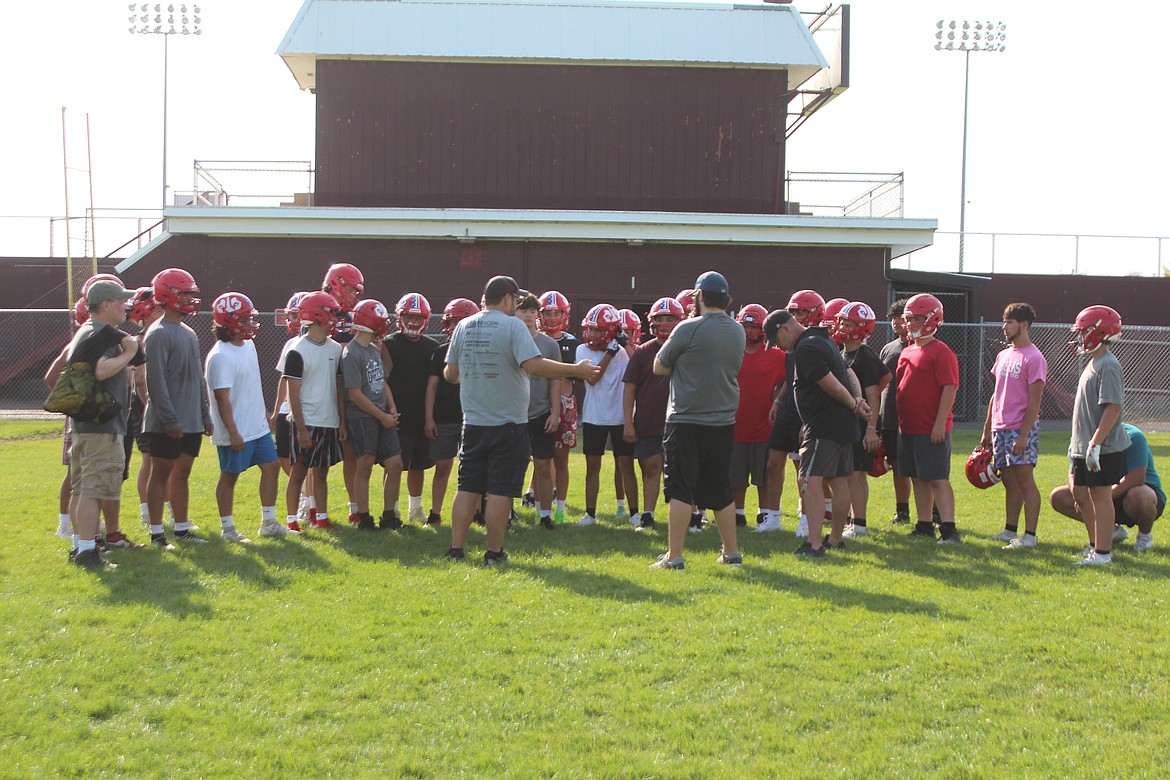 Othello defensive players gather round the coaches for some instruction.