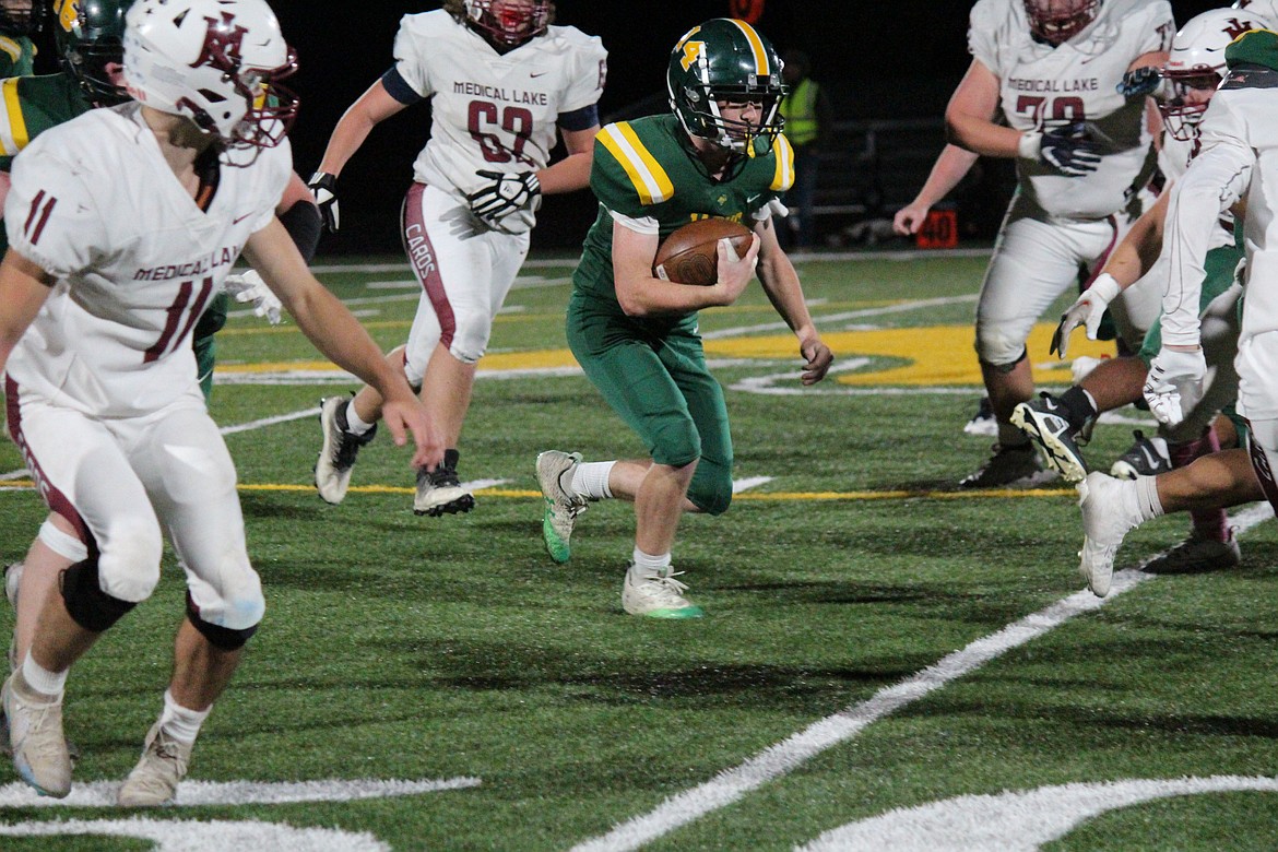 Quincy running back Jaxson Ferguson (14) weaves his way downfield in the Jacks’ win over Medical Lake in 2023. Jacks Coach Russ Elliott said Ferguson has emerged as a leader on the 2024 team.