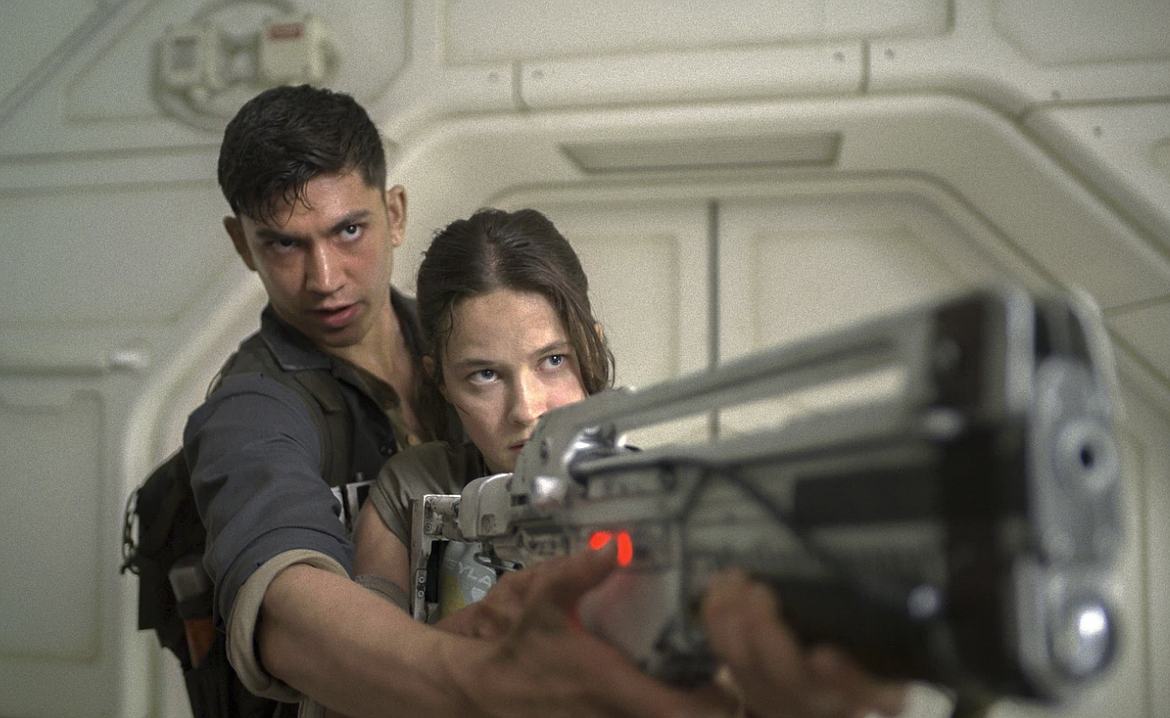 This image released by 20th Century Studios shows Archie Renaux, left, and Cailee Spaeny in a scene from "Alien: Romulus."