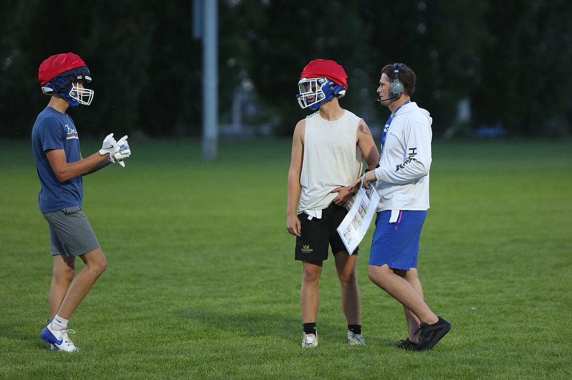 Second-year Head Coach Dallyn McLean talks with players during team drills at practice on August 22.