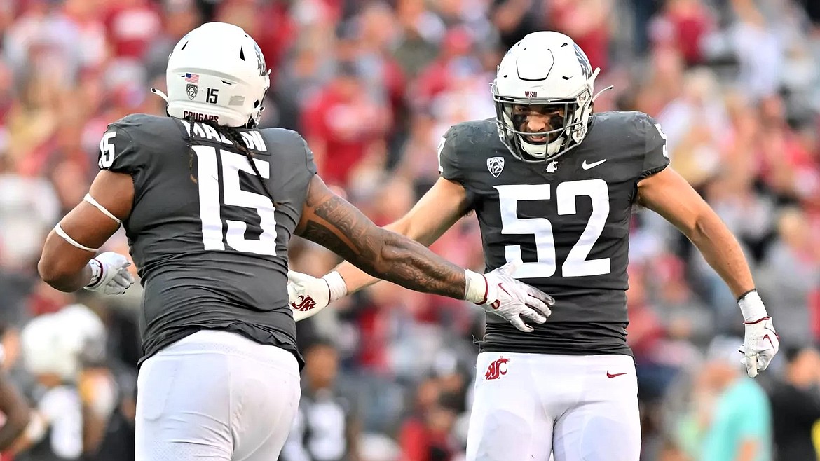 Cougar edge Nusi Malani (15) and linebacker Kyle Thornton (52) celebrate after a play against Oregon State last season. The Washington State Cougars open the 2024 season at home against Portland State on Saturday.