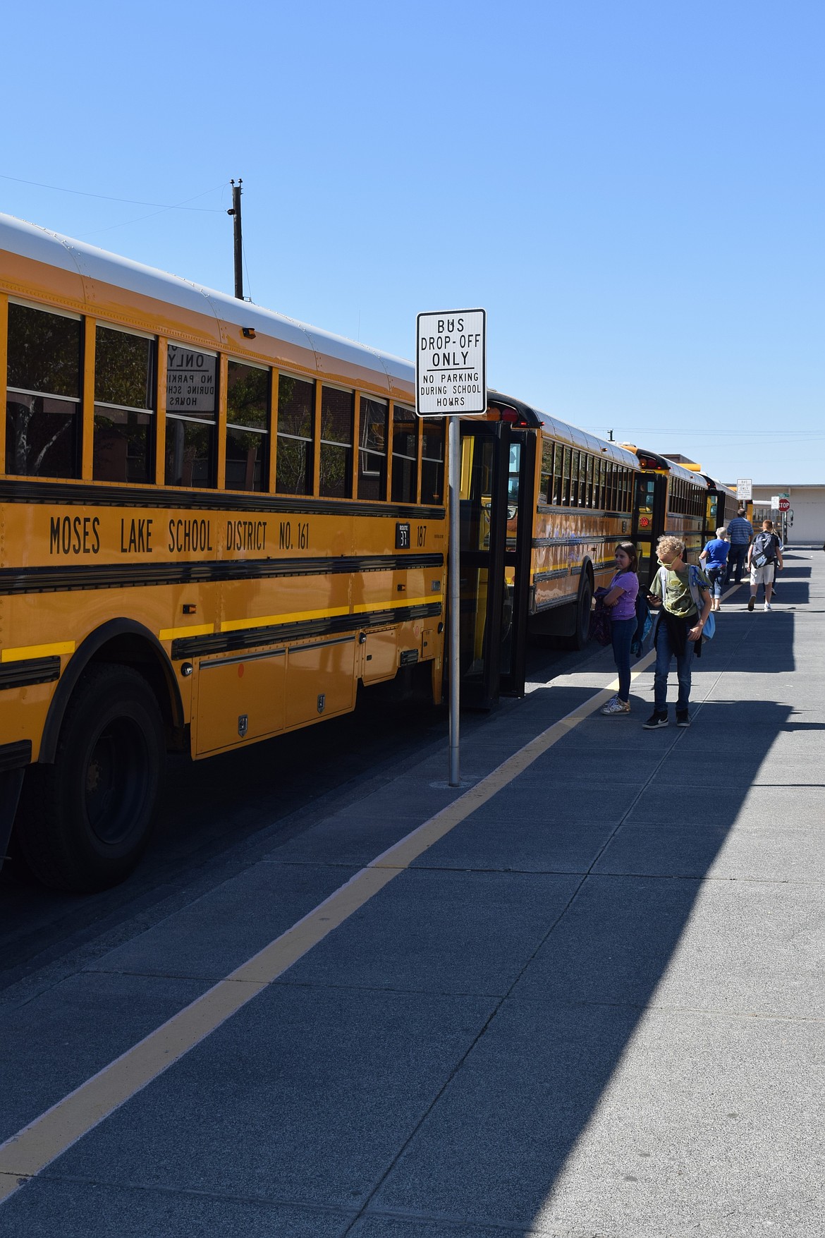 Frontier middle school students receive help from teachers and staff to find the correct bus on their first day back at school on Aug. 28.