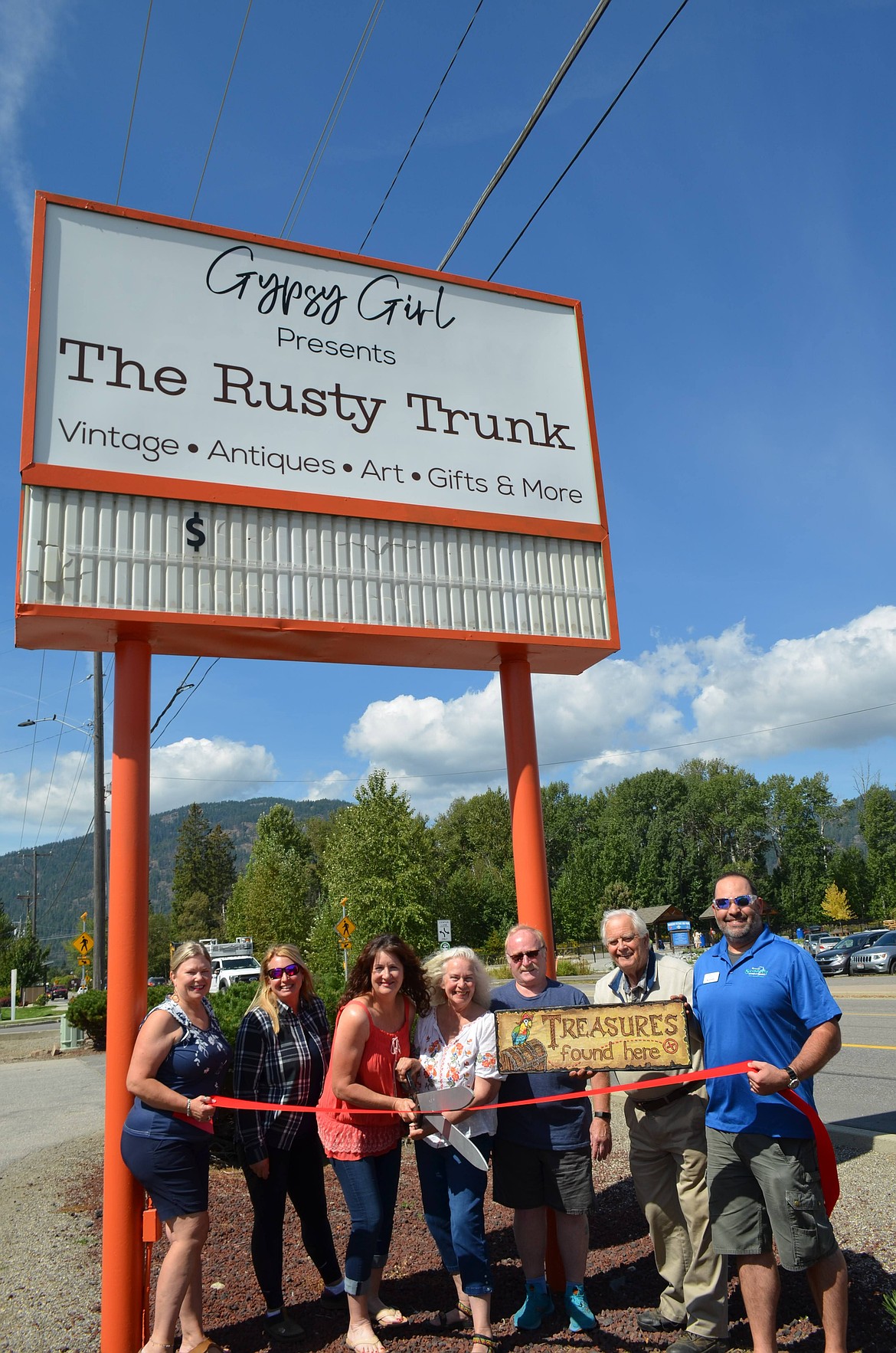 Greater Sandpoint Chamber of Commerce officials join representatives from The Rusty Trunk at a ribbon-cutting event. A week activities and bargains to commemorate the store's first anniversary will begin Monday, Sept. 2. Pictured are Chamber Ambassador Vicki Jacobson, Renee Nelson, The Rusty Trunk owner Julia Kern, store manager Jan Christians, Mike Doyle, Dwayne Parsons, and Chamber Ambassador Steve Sanchez.