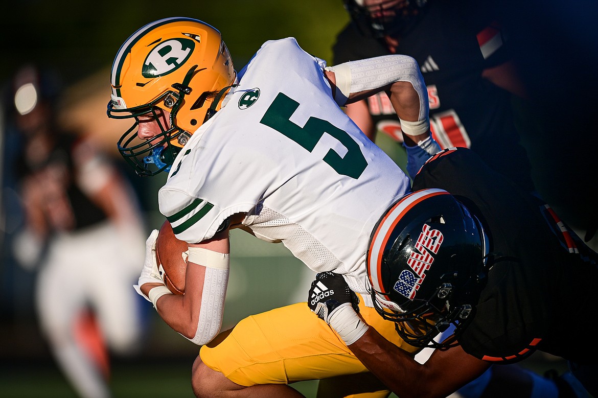 Great Falls CMR wide receiver Drew Etcheberry (5) is brought down by Flathead safety Tim Zundel (0) in the second quarter at Legends Stadium on Friday, Aug. 30. (Casey Kreider/Daily Inter Lake)