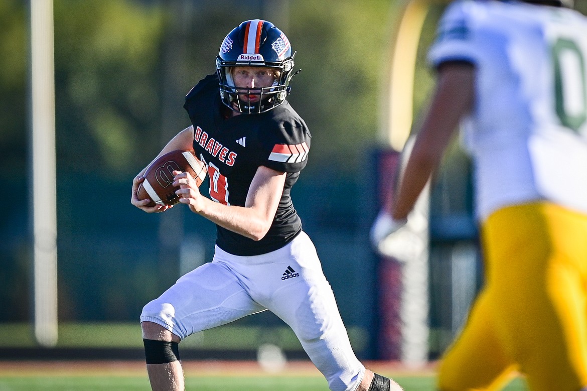 Flathead quarterback Brett Pesola (4) looks for running room in the first quarter against Great Falls CMR at Legends Stadium on Friday, Aug. 30. (Casey Kreider/Daily Inter Lake)