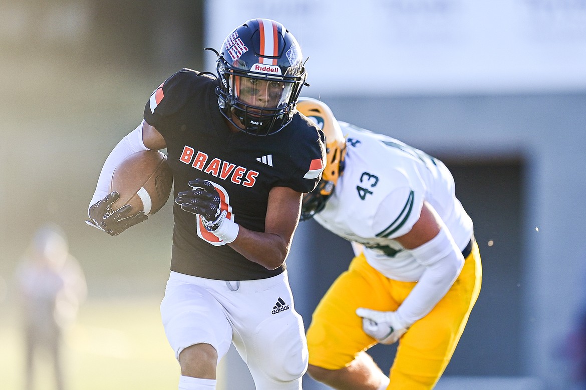 Flathead running back Tim Zundel (0) looks for running room against Great Falls CMR at Legends Stadium on Friday, Aug. 30. (Casey Kreider/Daily Inter Lake)