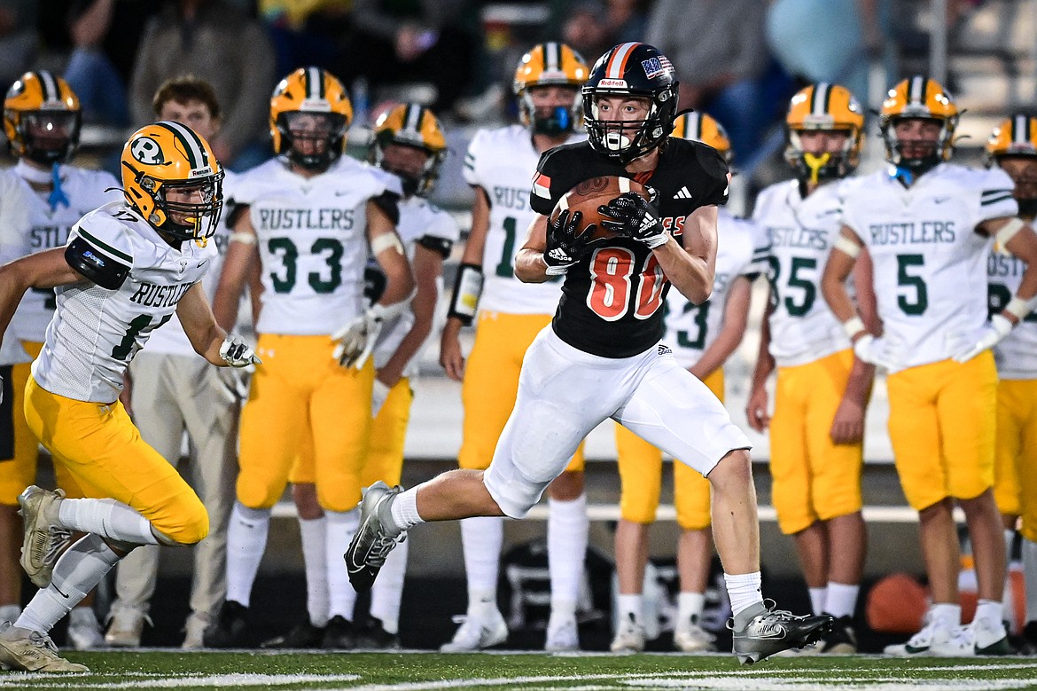 Flathead wide receiver Jack Blodgett (80) holds on to a 62-yard reception along the sideline in the second half against Great Falls CMR at Legends Stadium on Friday, Aug. 30. (Casey Kreider/Daily Inter Lake)