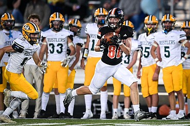 Flathead wide receiver Jack Blodgett (80) holds on to a 62-yard reception along the sideline in the second half against Great Falls CMR at Legends Stadium on Friday, Aug. 30. (Casey Kreider/Daily Inter Lake)