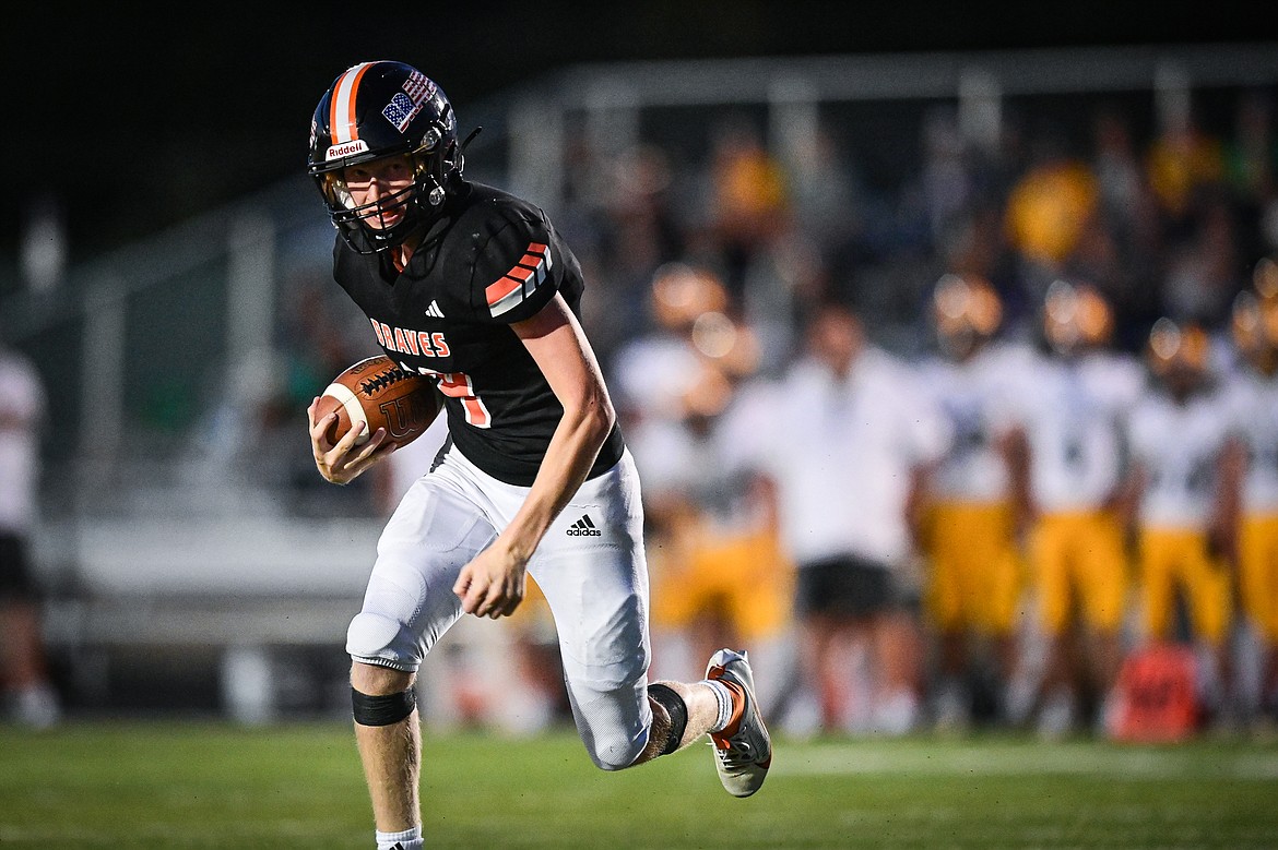 Flathead quarterback Brett Pesola (4) scores a touchdown on a 14-yard run in the third quarter against Great Falls CMR at Legends Stadium on Friday, Aug. 30. (Casey Kreider/Daily Inter Lake)