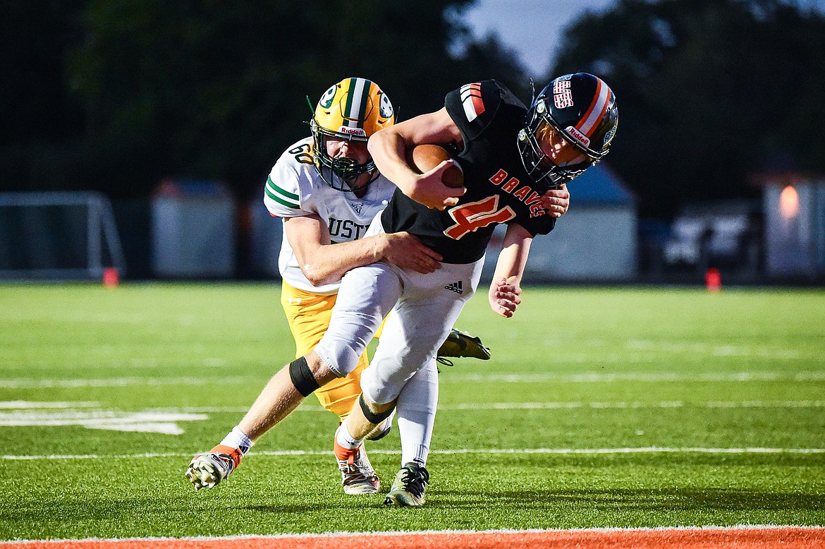 Flathead quarterback Brett Pesola (4) scores a touchdown on a 14-yard run in the third quarter against Great Falls CMR at Legends Stadium on Friday, Aug. 30. (Casey Kreider/Daily Inter Lake)