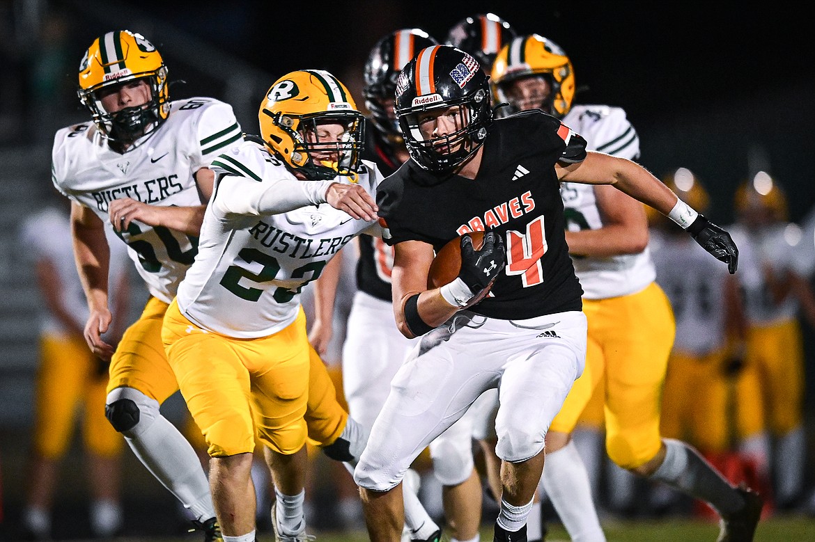 Flathead running back Nolan Campbell (24) picks up yardage on a run  in the second half against Great Falls CMR at Legends Stadium on Friday, Aug. 30. (Casey Kreider/Daily Inter Lake)