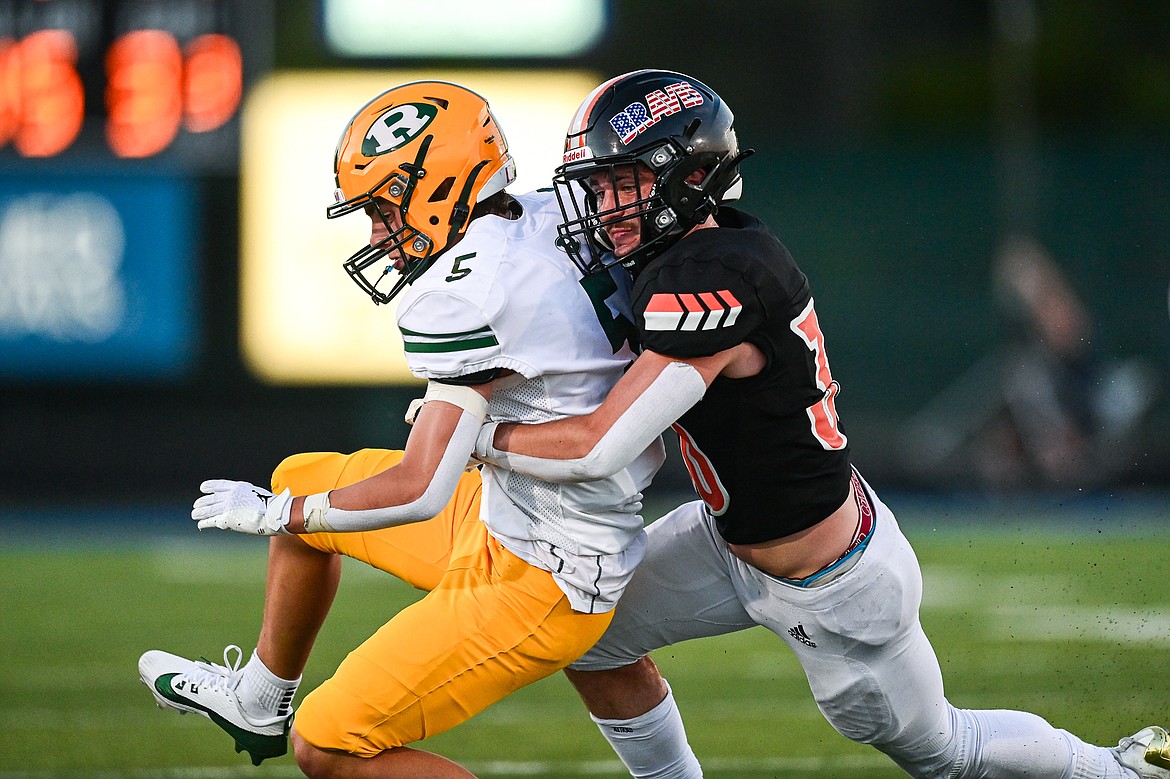 Flathead linebacker Brayton Fitch (30) wraps up Great Falls CMR wide receiver Drew Etcheberry (5) at Legends Stadium on Friday, Aug. 30. (Casey Kreider/Daily Inter Lake)