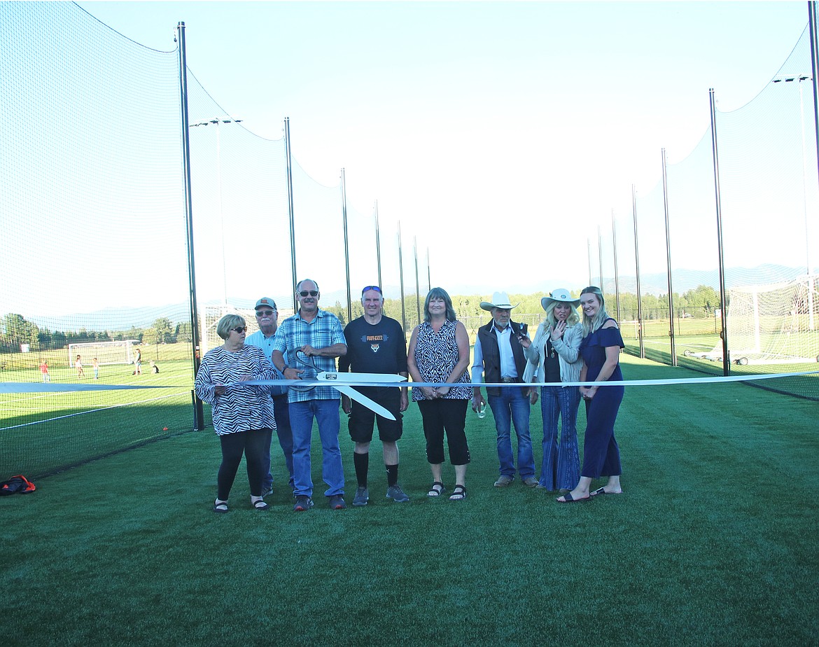 Ponderay officials and members of the Floyd McGhee and Mike Read families cut a ribbon to mark the formal opening of the Field of Dreams.