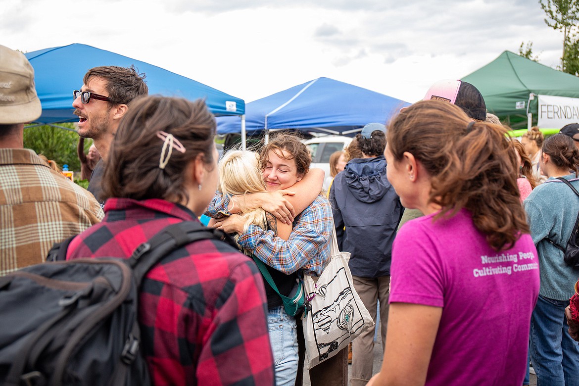 People embrace at a gathering in Whitefish in honor of Grant Marcuccio's life. (Andrea Getts Photo)