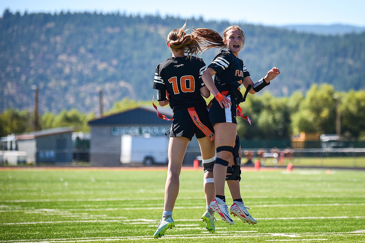 Flathead's Courtney Hendrickson (10) and Kenlie Roth (2) celebrate after Roth's touchdown run in the first half against Butte at the Kalispell Jamboree at Legends Stadium on Saturday, Aug. 31. (Casey Kreider/Daily Inter Lake)