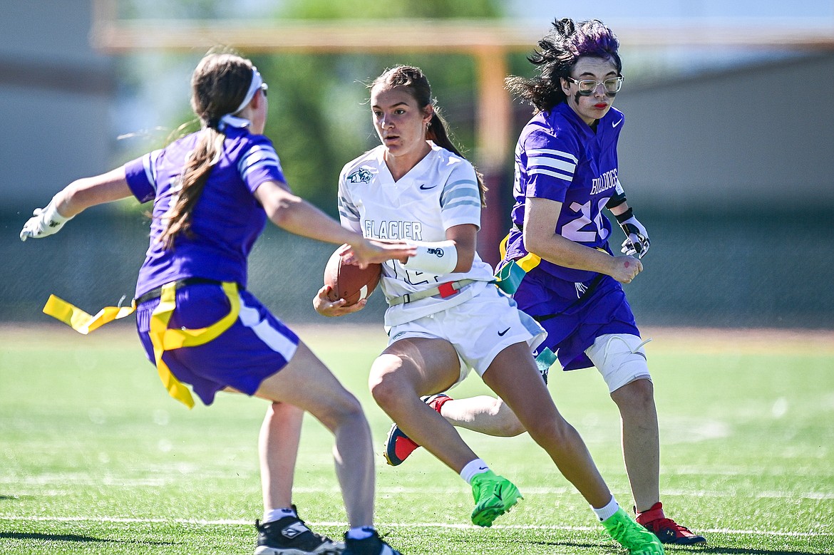 Glacier quarterback Karley Allen (14) splits a pair of Butte defenders on a run at the Kalispell Jamboree at Legends Stadium on Saturday, Aug. 31. (Casey Kreider/Daily Inter Lake)