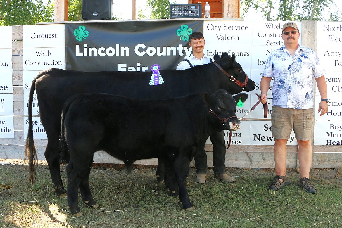 Nick Harper and his dad, Chad Harper, show off his cow/calf pair at the 2024 Lincoln County Fair. (Photo courtesy Svetlana Harper)