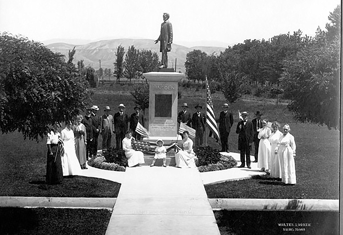 A group of people pose with a statue of Lincoln in this photo shared by the Idaho State Historical Society.