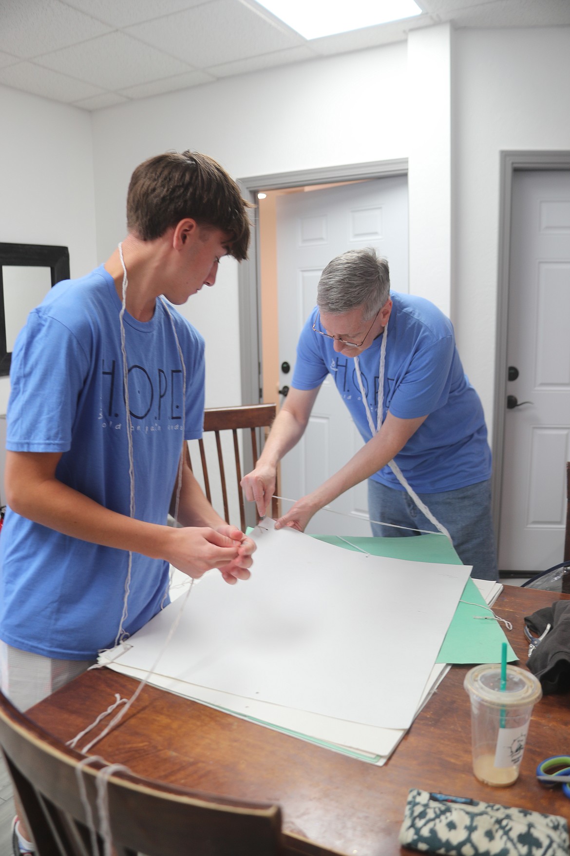 Brennan Wyman and Lee Thompson get signs ready to hang up during Sunday's Walk For HOPE. The annual walk is being held today to spread a message of hope and awareness during Suicide Awareness Month.