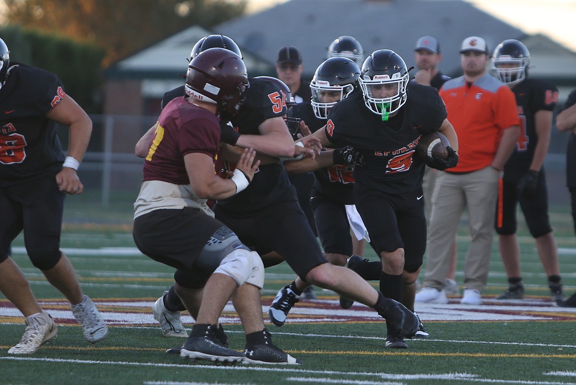 The Ephrata offense moves up the field on a run play against the Moses Lake defense on Friday.