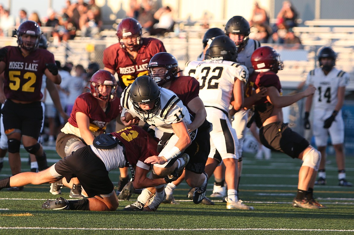 Royal quarterback Lance Allred (11) powers through tackles on a touchdown run against the Maverick defense.