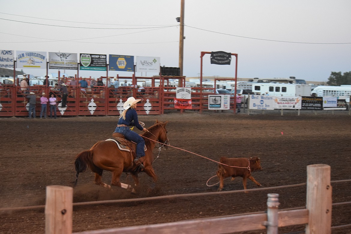 One of the cowgirls catches her calf during the breakaway event at the Ritzville Rodeo on Aug. 30.