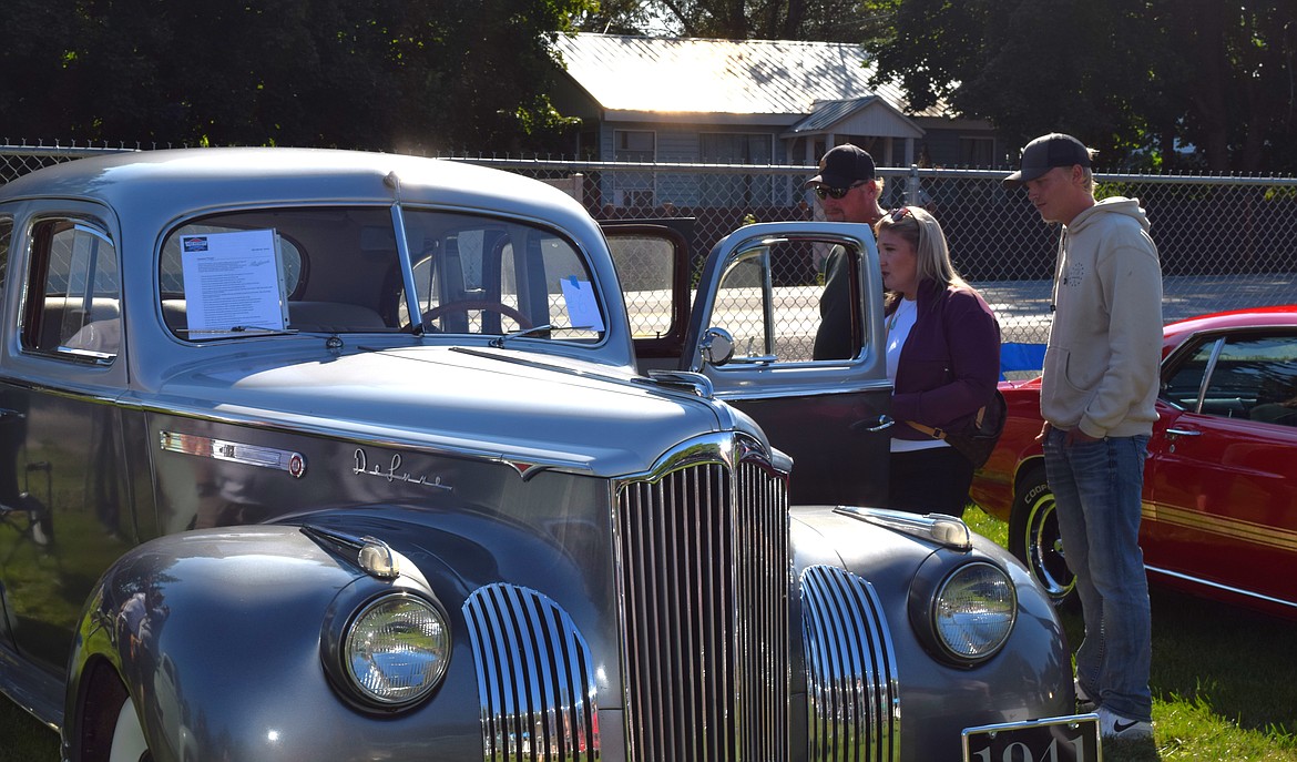 Community members admire the beautifully restored interior of this 1941 Packard 110 at Spirit Lake's yearly Labor Day Car Show.