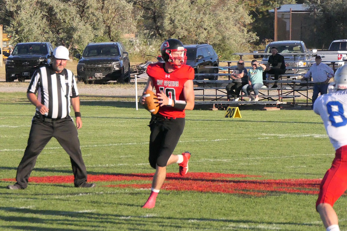 Hot Springs senior quarterback Nick McAlliser rolls out and looks downfield for an open receiving during the Heat's season opener with Denton Friday night in Hot Springs.  (Chuck Bandel/VP-MI)