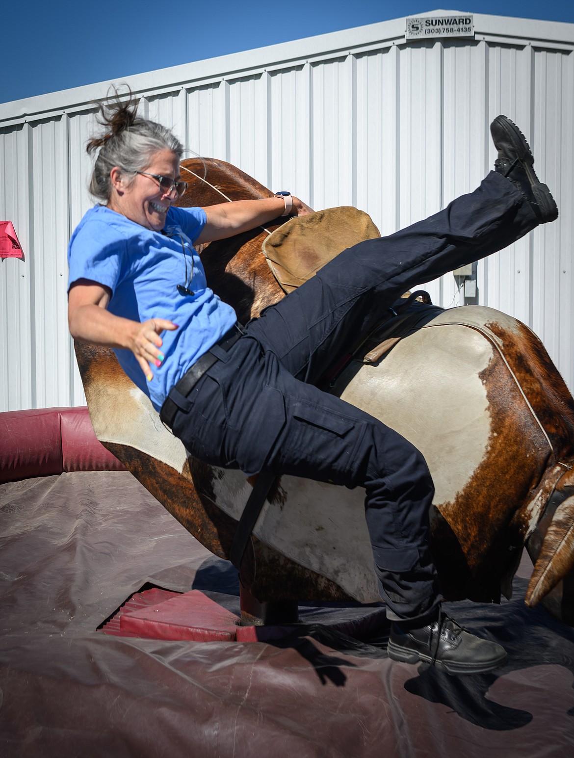 Plains Community Ambulance and EMT member Shelley_Bertrand on the mechanical bull. (Tracy Scott/Valley Press)