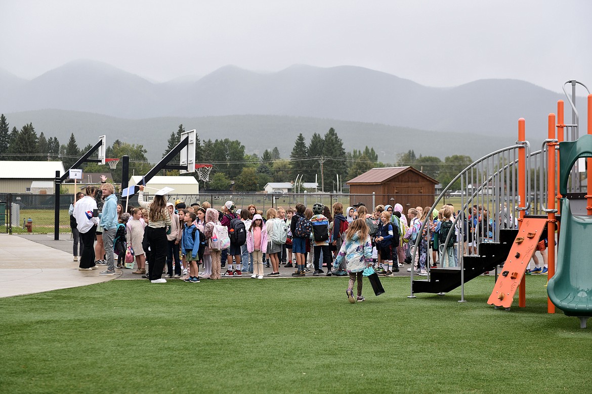 Students line up with their classes for a rainy first day of school at Muldown Elementary Aug. 28. (Kelsey Evans/Whitefish Pilot)