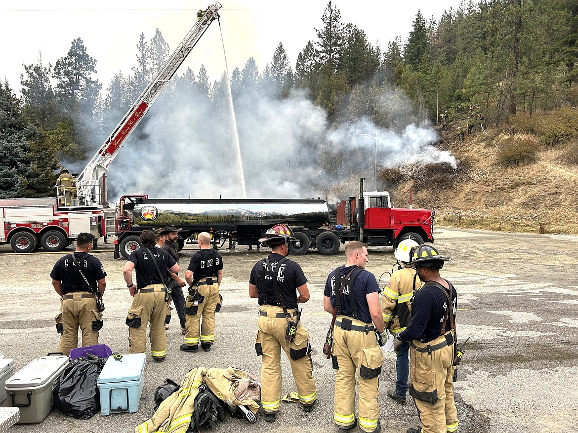 Firefighters take a breather from battling the blaze at the Wolf Lodge Steakhouse on Monday.