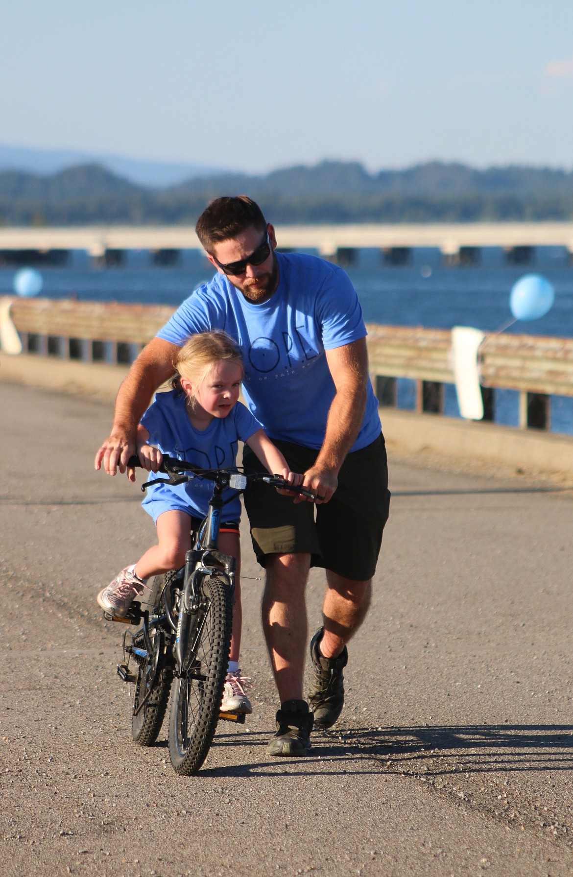 A youngster gets a helping hand as she takes part in the Walk for HOPE on Sunday.