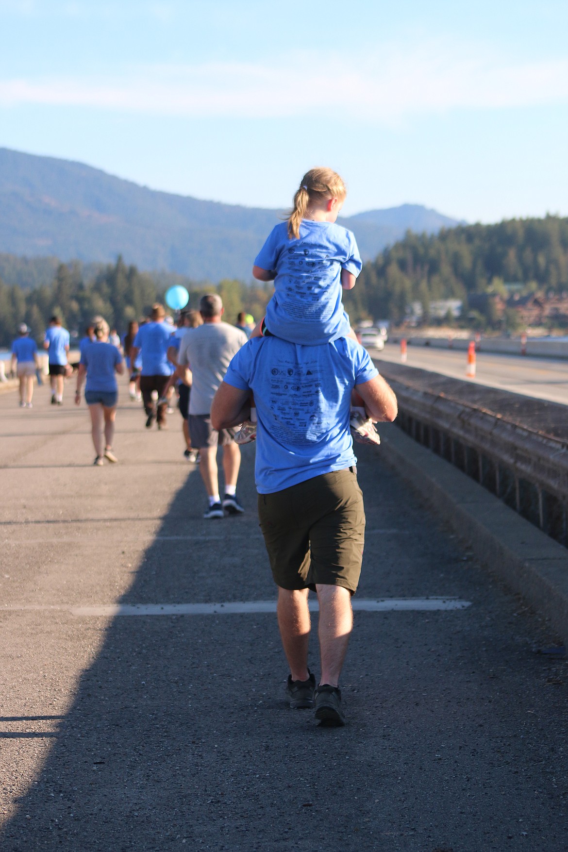 A young walker gets a lift during the Walk for HOPE on Sunday.