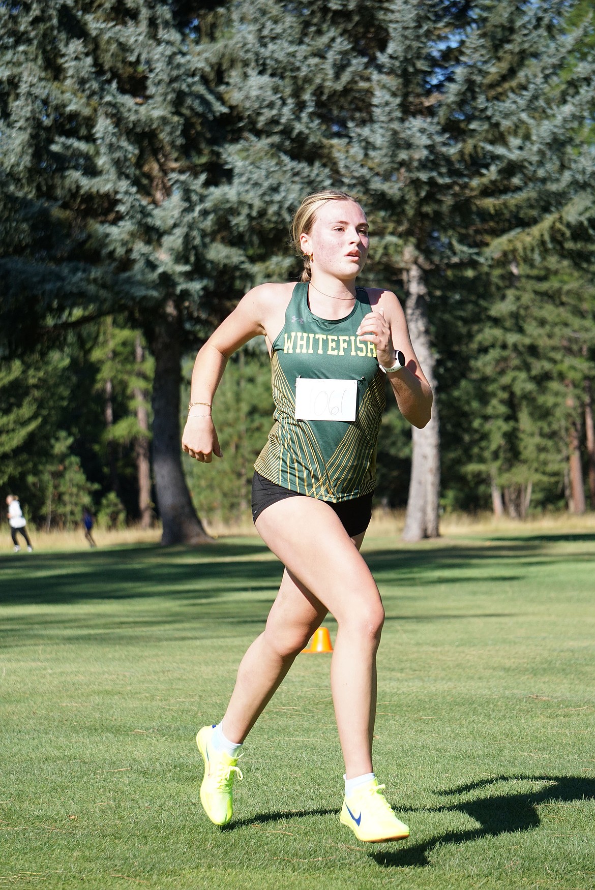 Senior Harrier, Charlotte Wallace, leads the varsity girls in their season opener in Libby on Friday. (Matt Weller Photo)