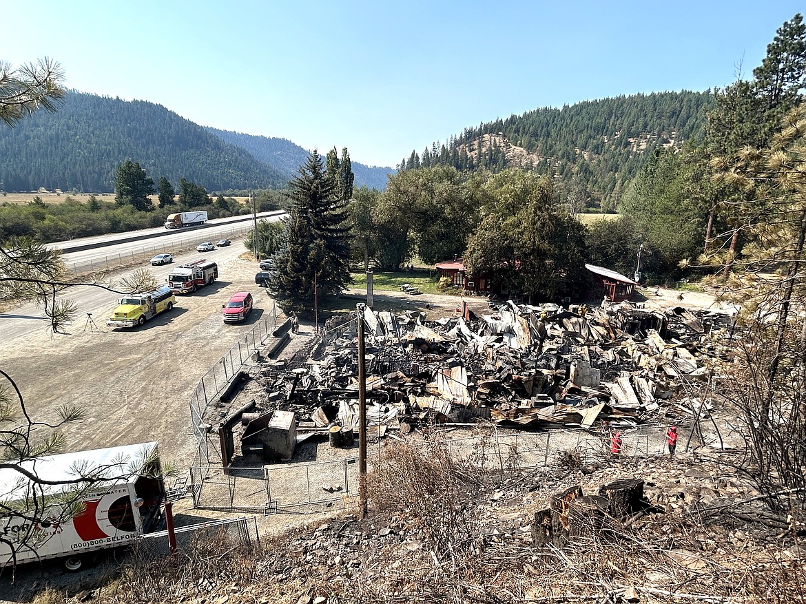 Traffic on Interstate 90 passes by the burned remains of the Wolf Lodge Steakhouse on Tuesday.