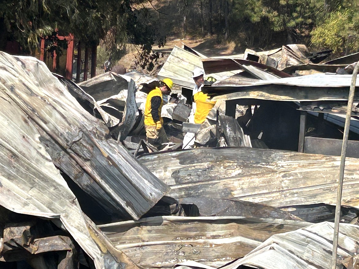 Investigators look through the remains of the Wolf Lodge Steakhouse on Tuesday.