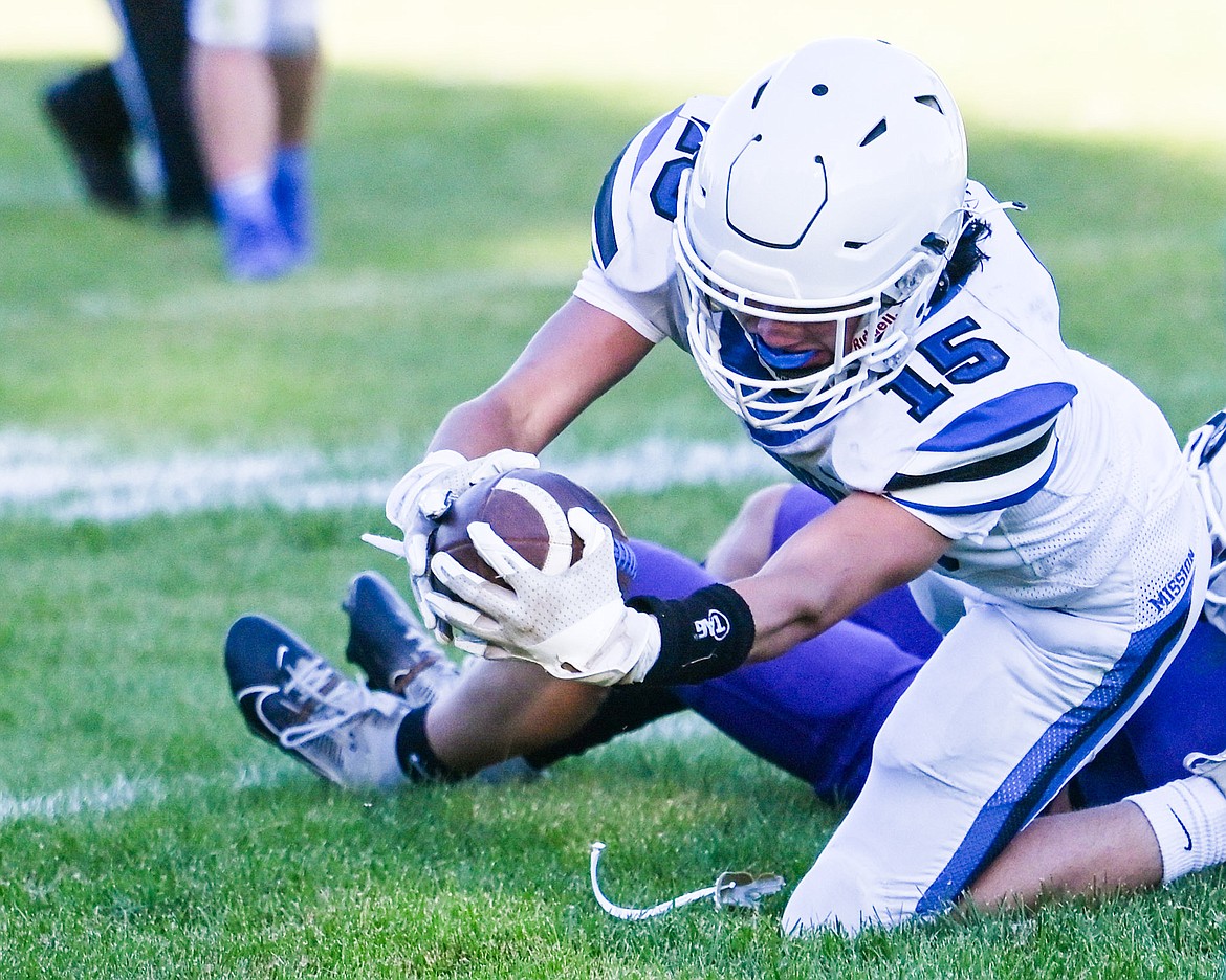 Bulldog Titan Mansell keeps a tight grip on the ball during last Friday's season opener against St. Regis. (Christa Umphrey photo)