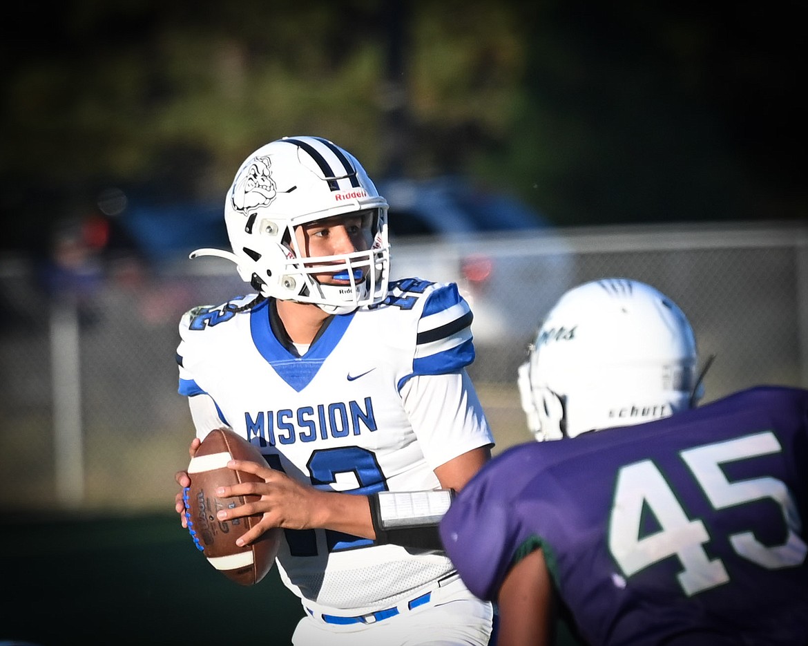 Mission's Vinny Shepard prepares to pass the ball during Friday's game against St. Regis. St. Ignatius handily beat the Tigers 34-8. (Christa Umphrey photo)